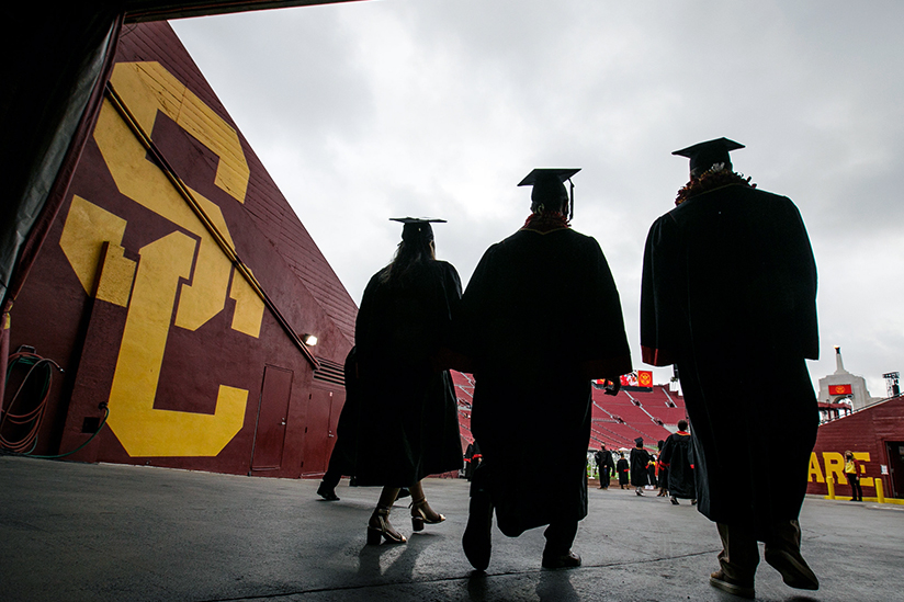 Three USC Grads walking to commencement